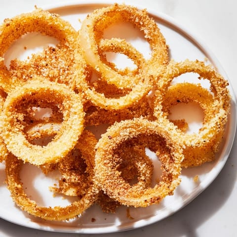 Perfectly fried onion rings, showcasing their delightful crunch, served hot after preparation.