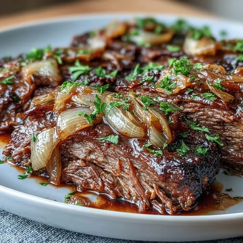Savory Crock Pot French Onion Pot Roast with tender beef, caramelized onions, and melted Gruyere in a slow cooker.