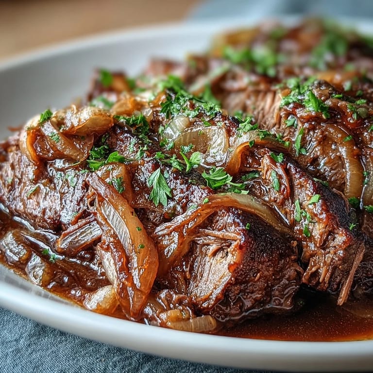 Slow-cooker Savory Crock Pot French Onion Pot Roast topped with gooey Gruyere, fresh parsley, and rich onion juices.