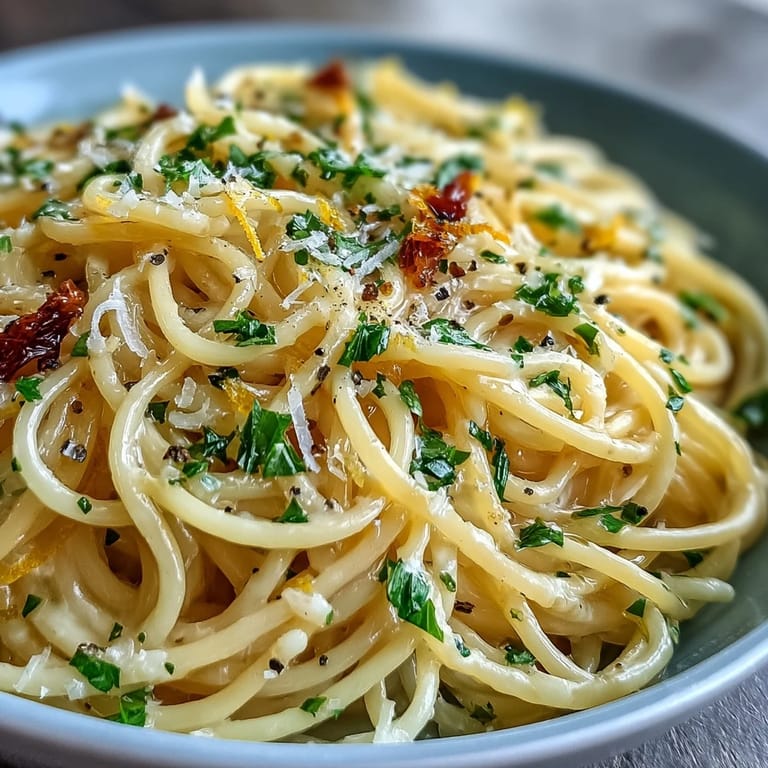 Creamy lemon butter pasta tossed with garlic and Parmesan, perfect for a quick and flavorful vegetarian dinner.  