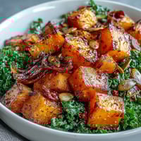 Golden roasted Sweet and Spicy Red Kuri Squash Bowl with fresh cilantro and pumpkin seeds.