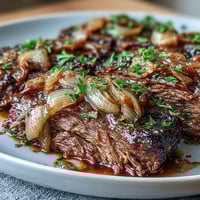 Savory Crock Pot French Onion Pot Roast with tender beef, caramelized onions, and melted Gruyere in a slow cooker.