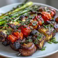 Colorful grilled vegetable skewers bursting with summer flavors, served with vibrant chimichurri sauce for a fresh and healthy meal.  