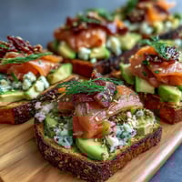 Spring Brunch Avocado Toast Board with Smoked Salmon, featuring creamy avocado, fresh vegetables, and smoked salmon on rustic bread.