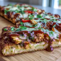 Smoky BBQ chicken flatbread pizza with melted mozzarella, red onion, and bell pepper, ready for a quick weeknight dinner.